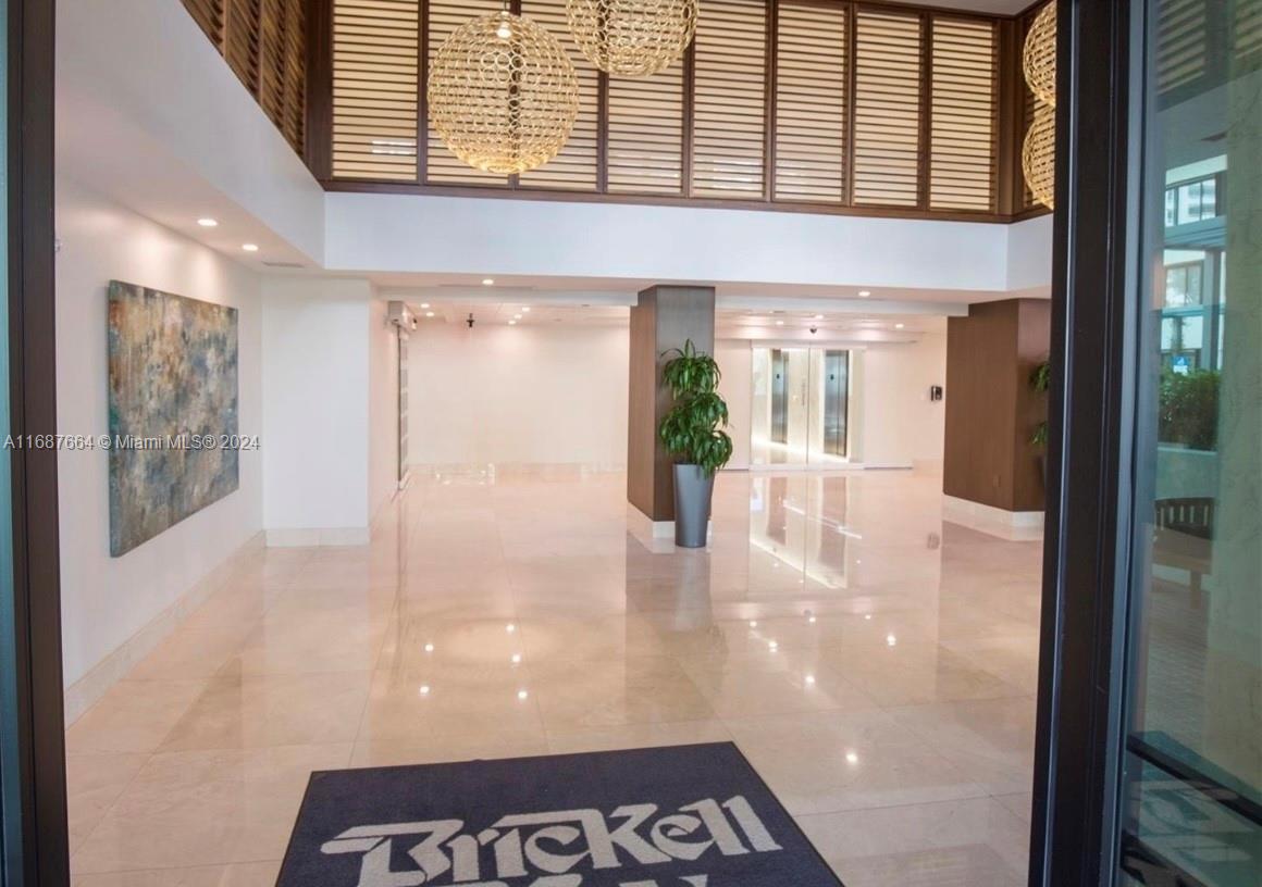 a view of a hallway with a dining table and chair