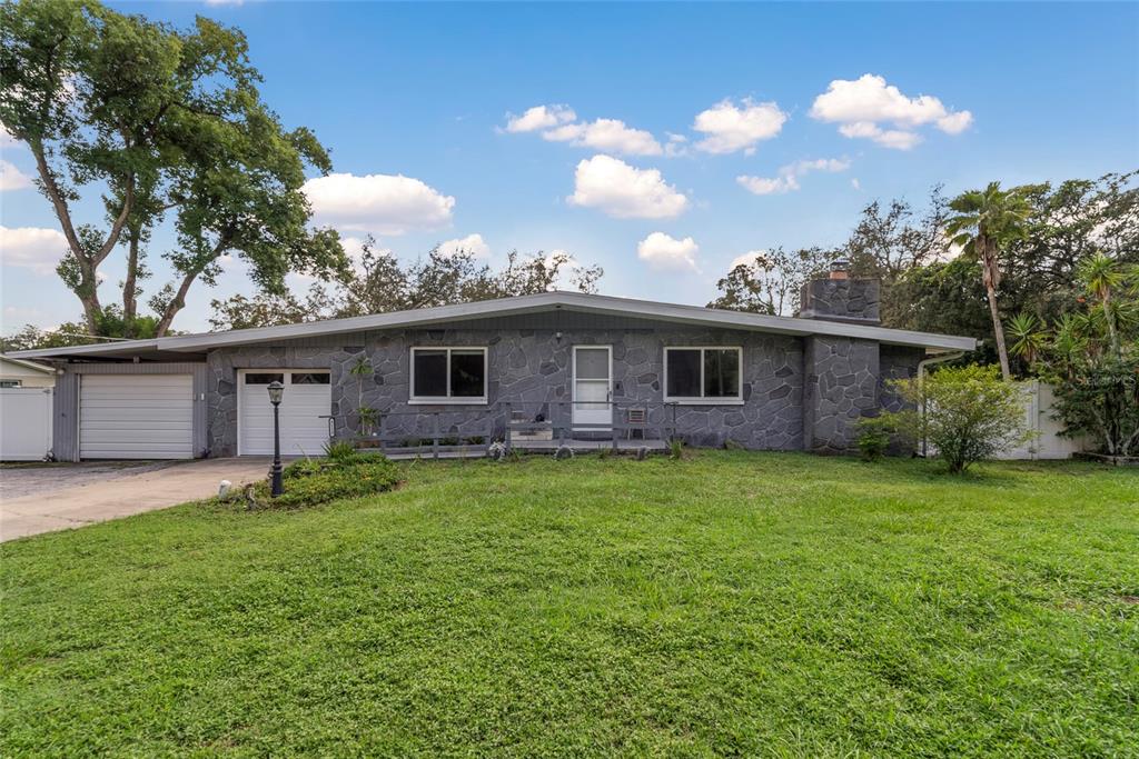 a view of a house with a backyard