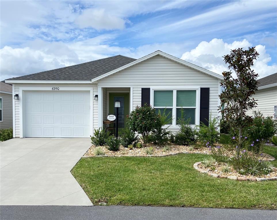 a front view of a house with garden