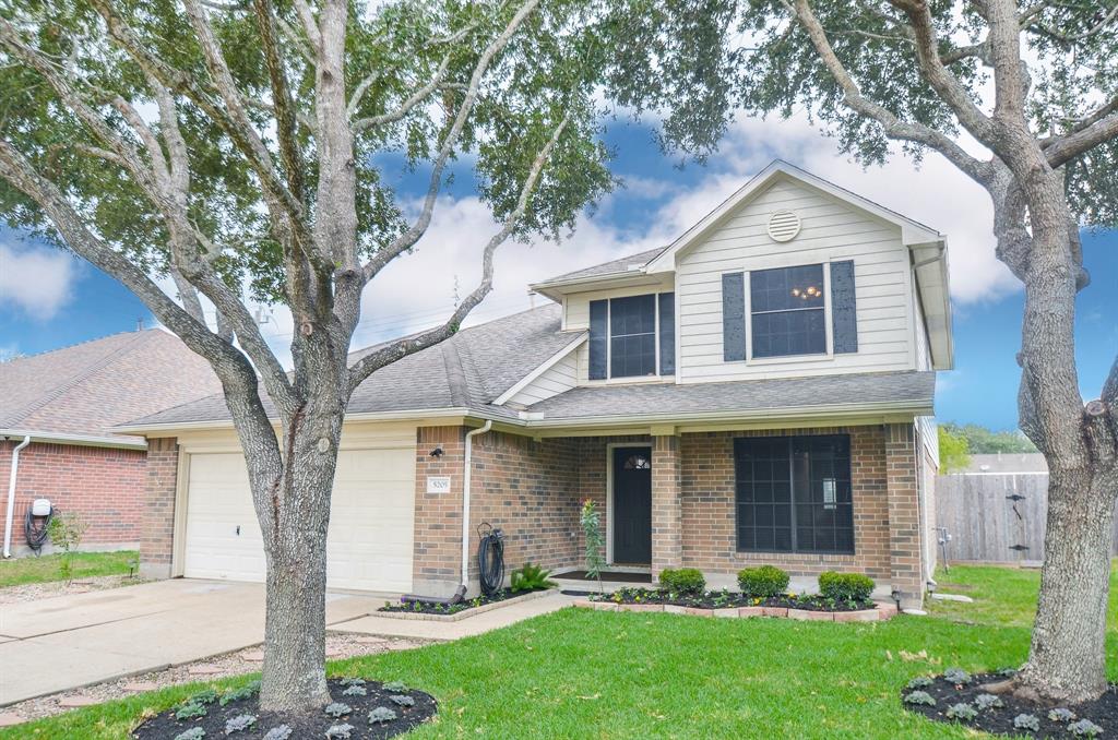 Pretty landscaping and a front porch too.