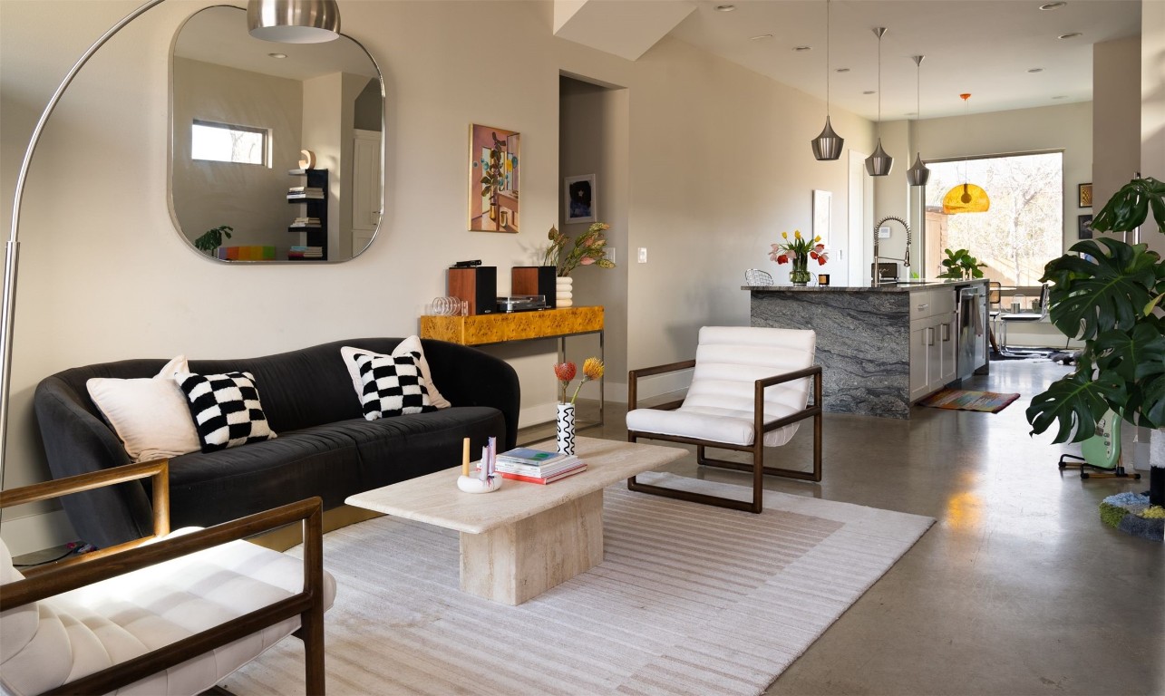 a living room with furniture and wooden floor