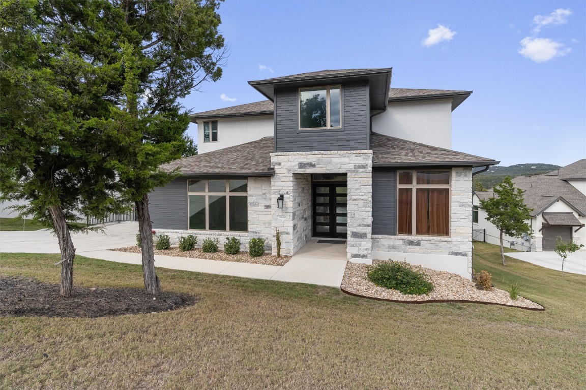 a front view of a house with garden