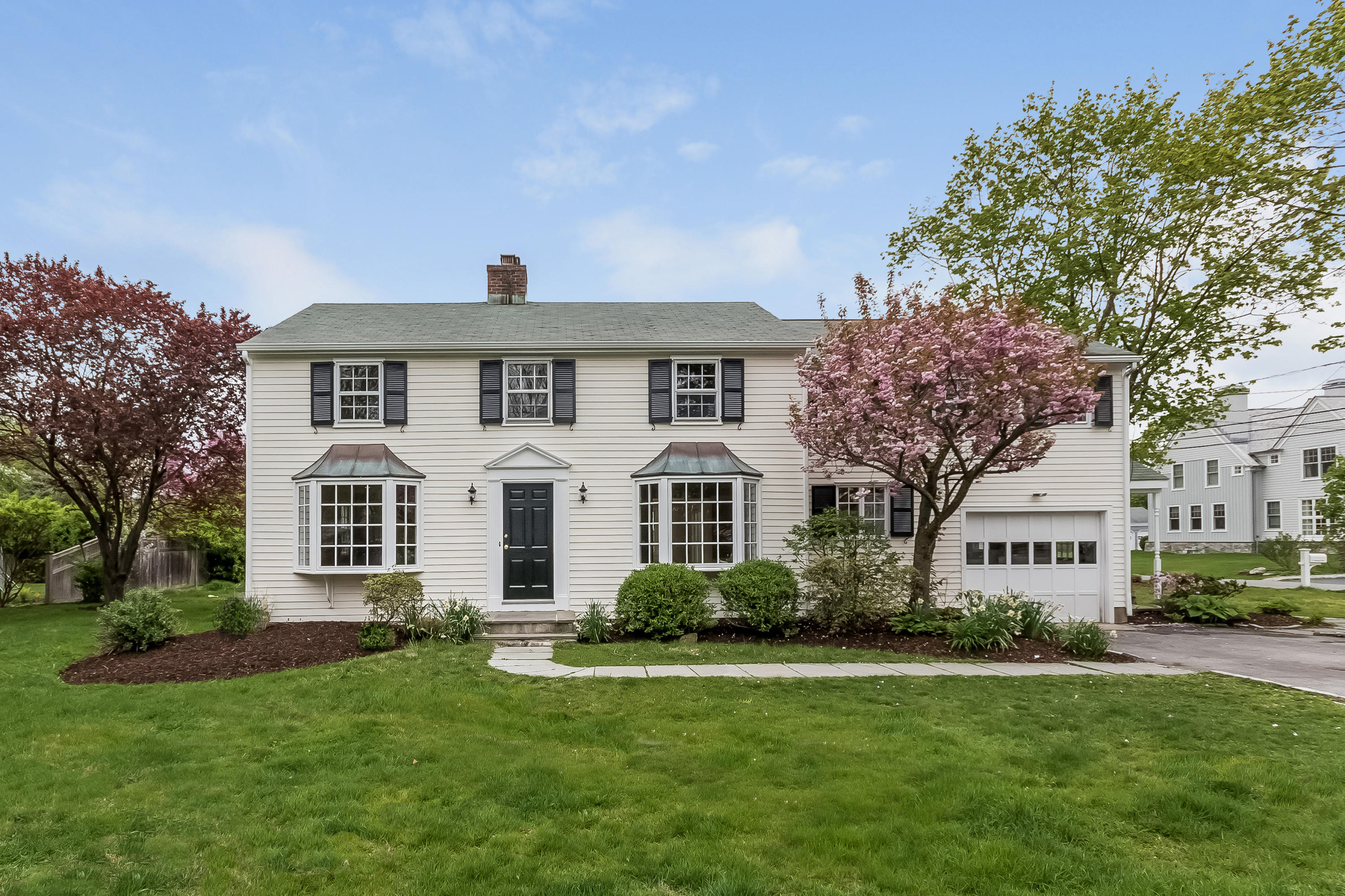 a front view of a house with a garden