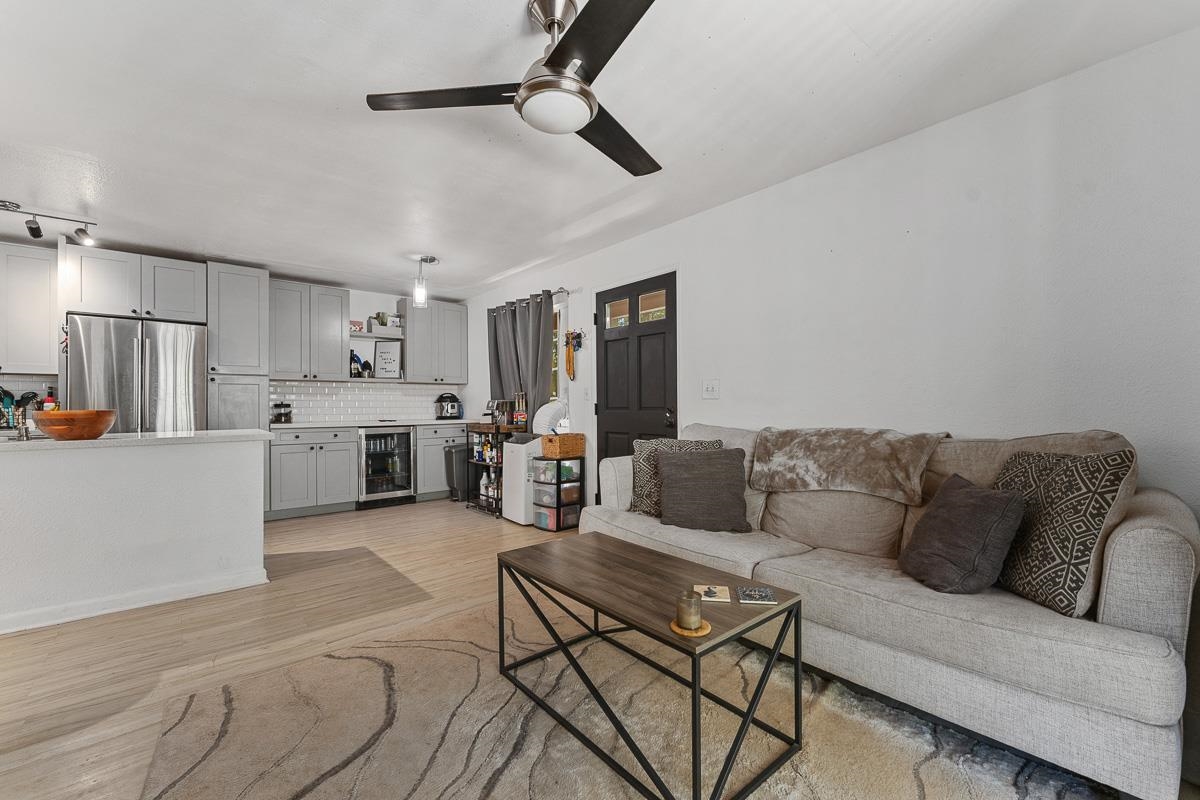 a living room with furniture and kitchen view