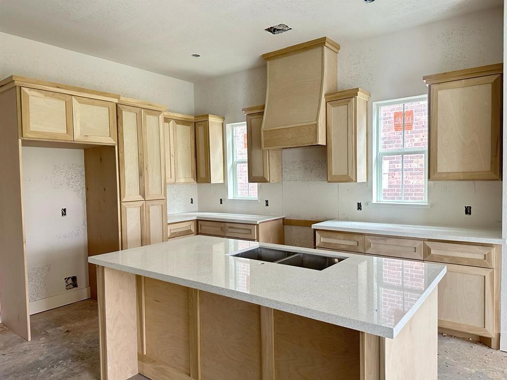 a kitchen that has a sink a window and stainless steel appliances