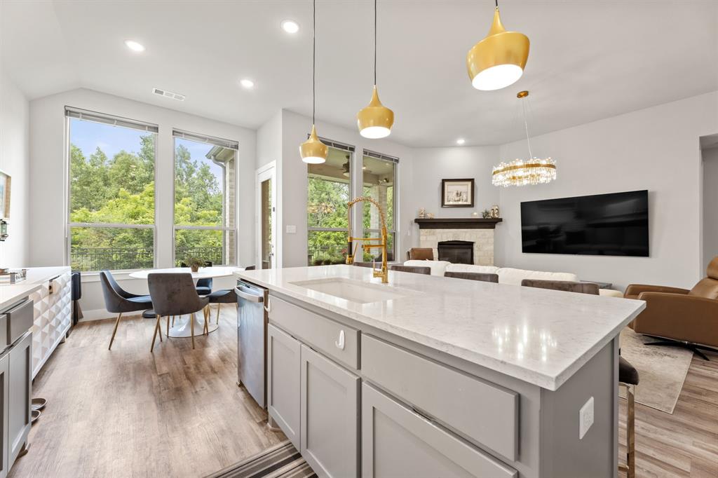 a view of living room with kitchen island furniture and a flat screen tv