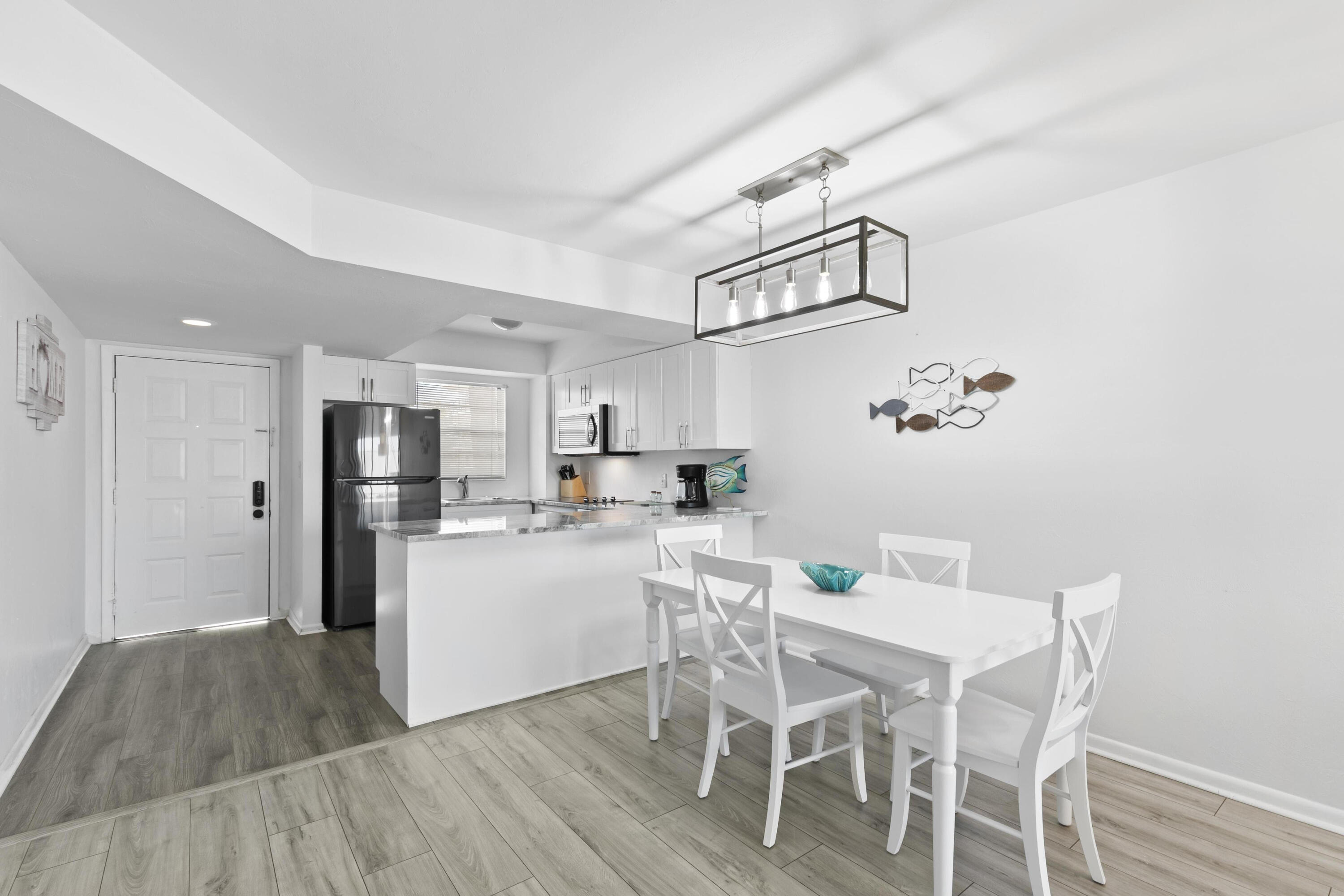 a kitchen with kitchen island wooden floors and stainless steel appliances