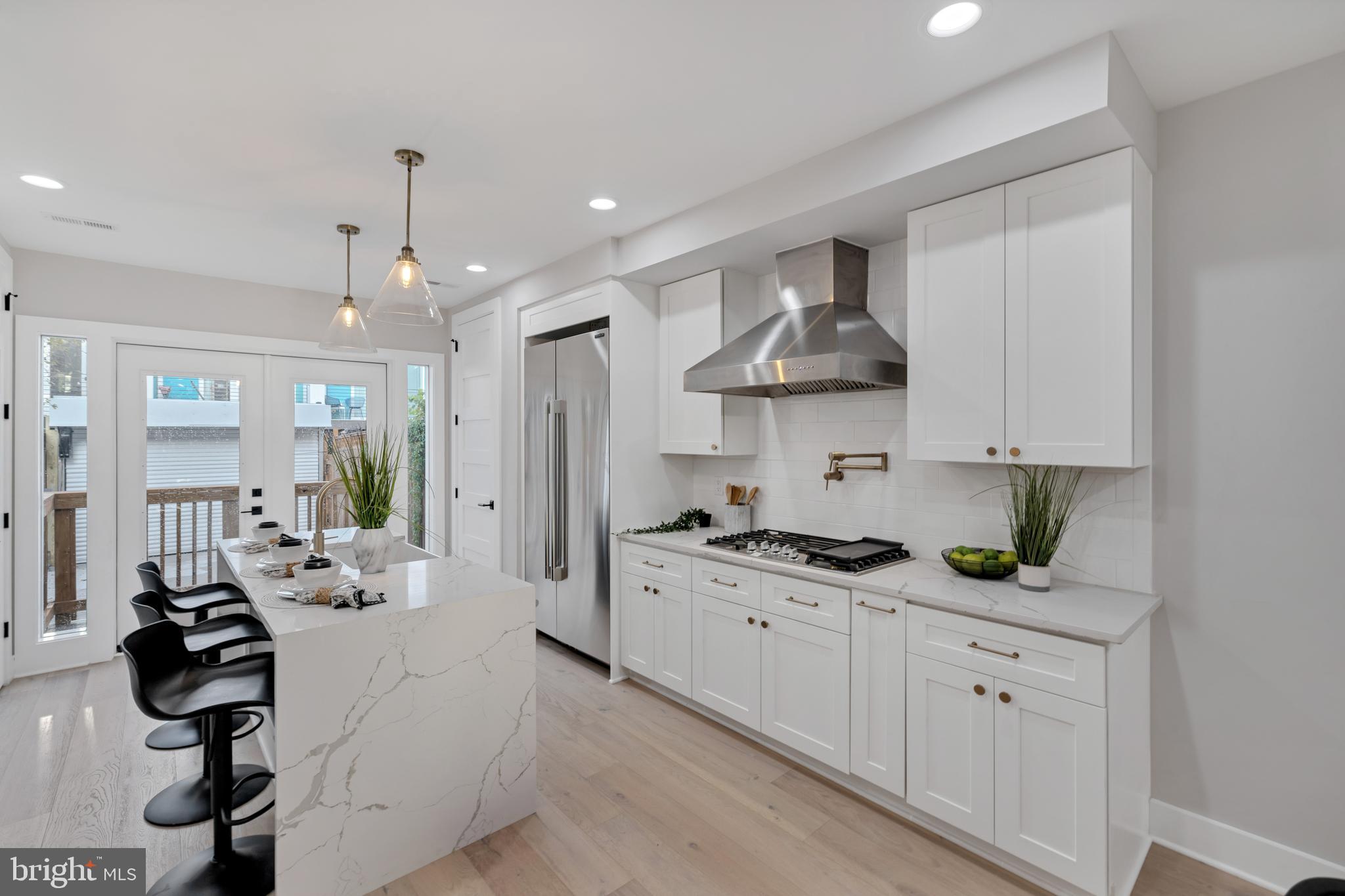 a kitchen with stainless steel appliances a sink stove and cabinets