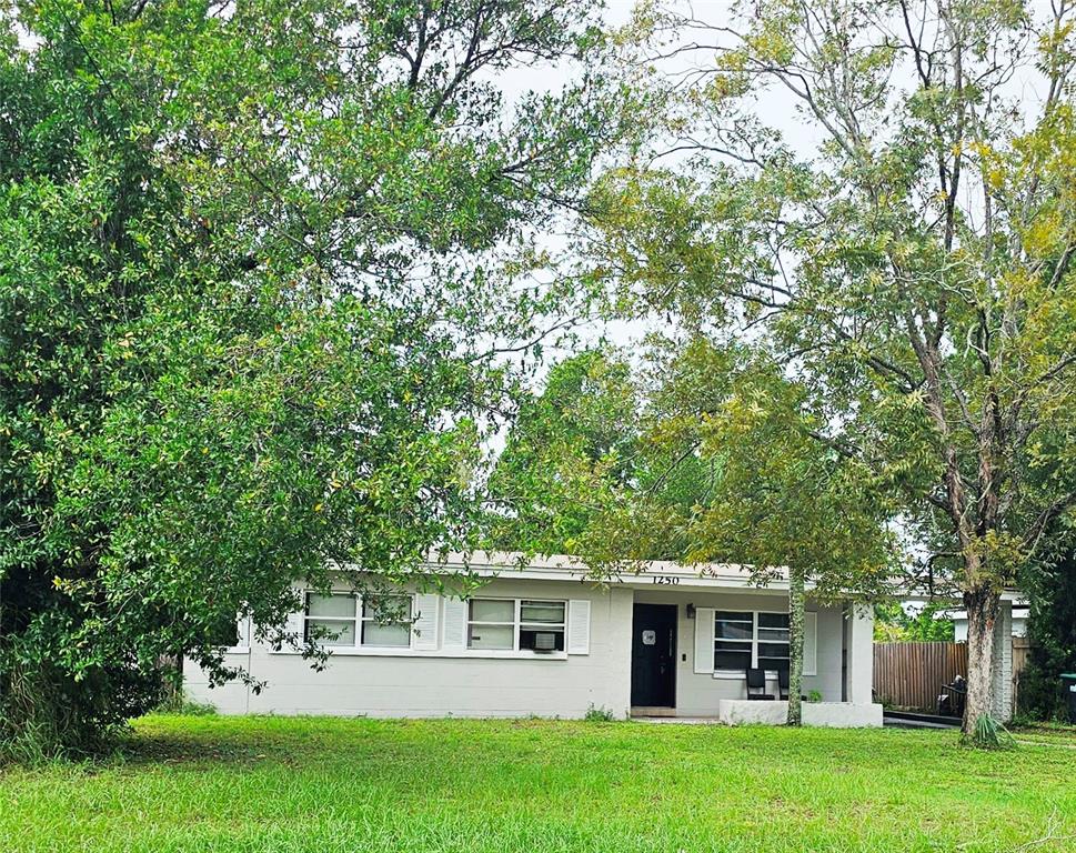 a view of a house with a backyard