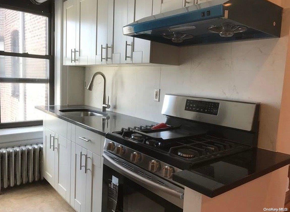 a stove top oven sitting inside of a kitchen