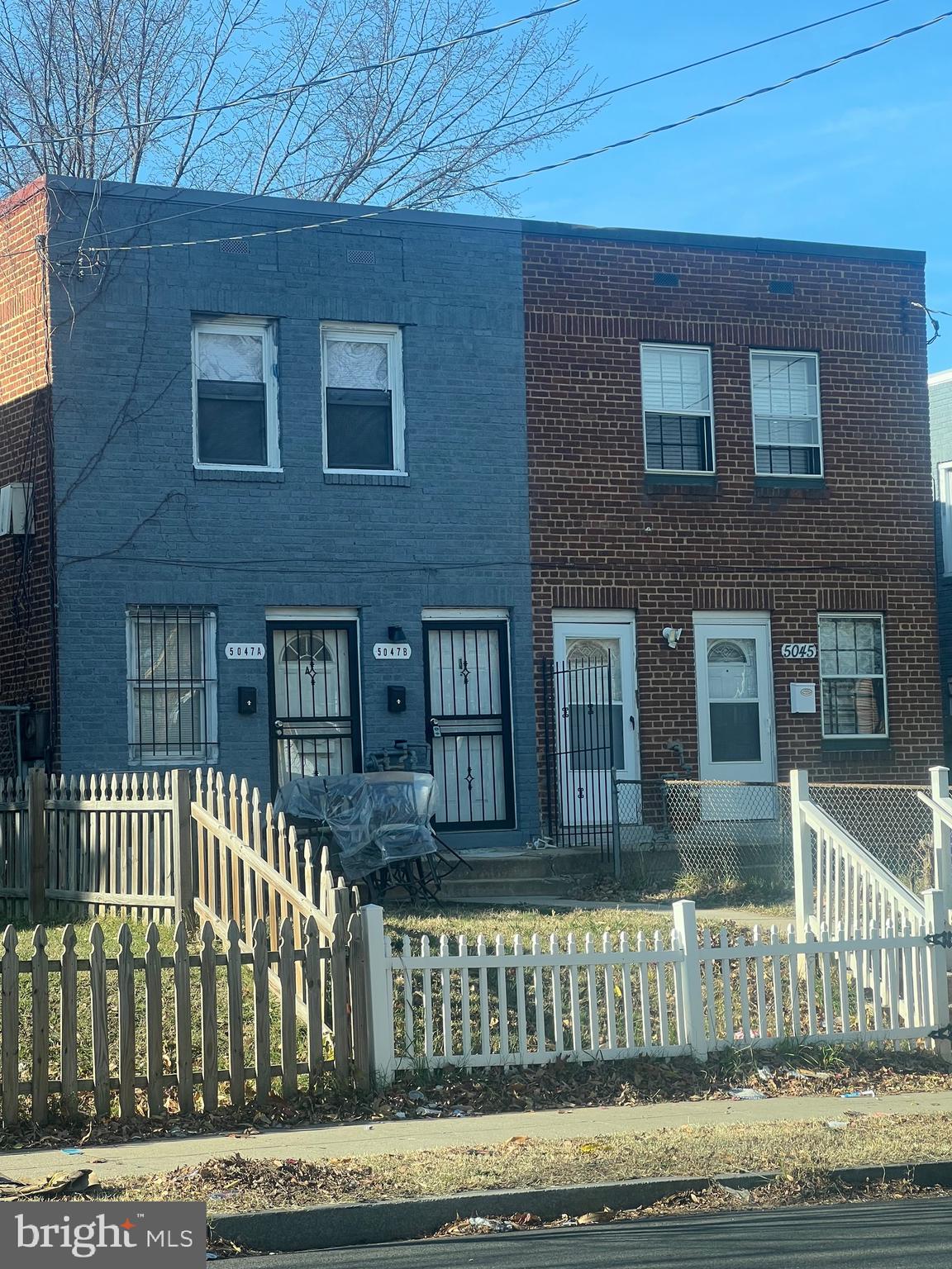 a front view of a house with a fence