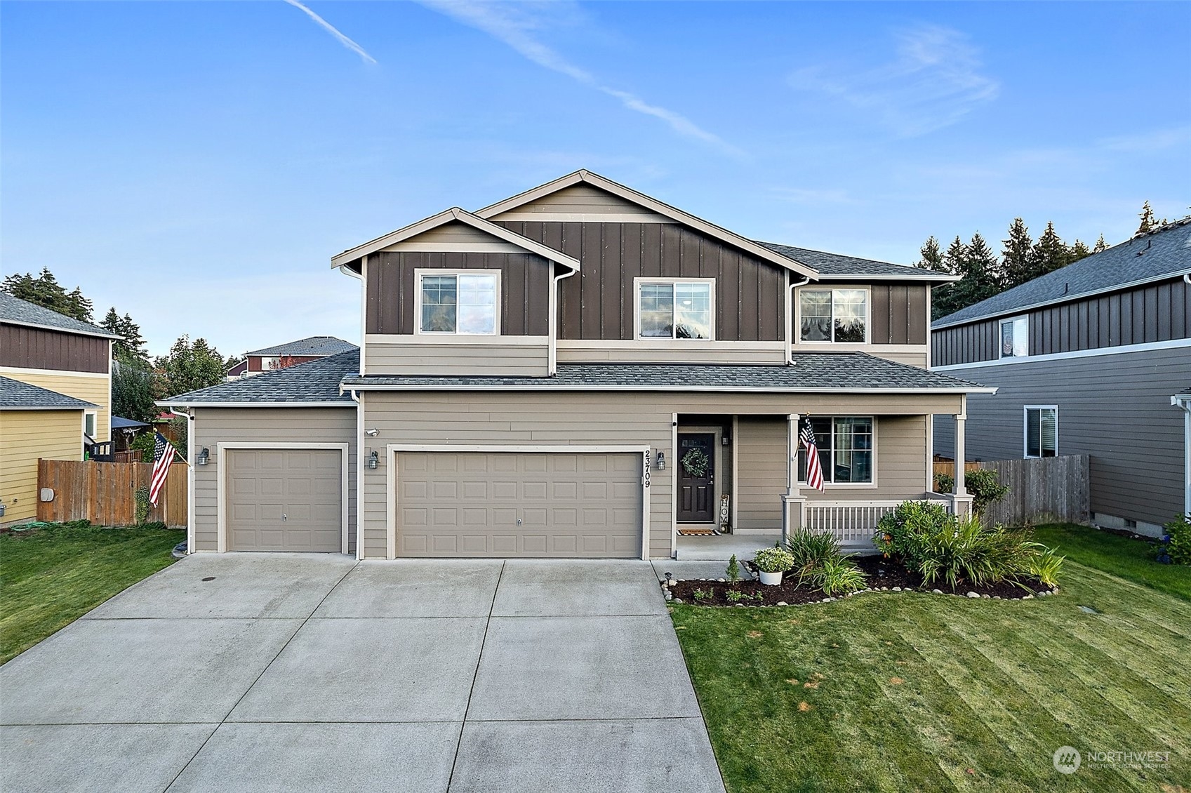 a front view of a house with a yard and garage