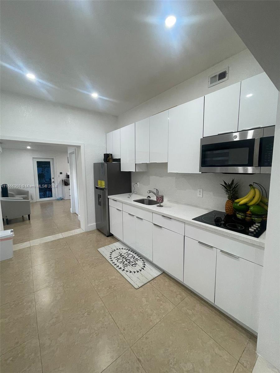 a kitchen with a sink a stove and cabinets