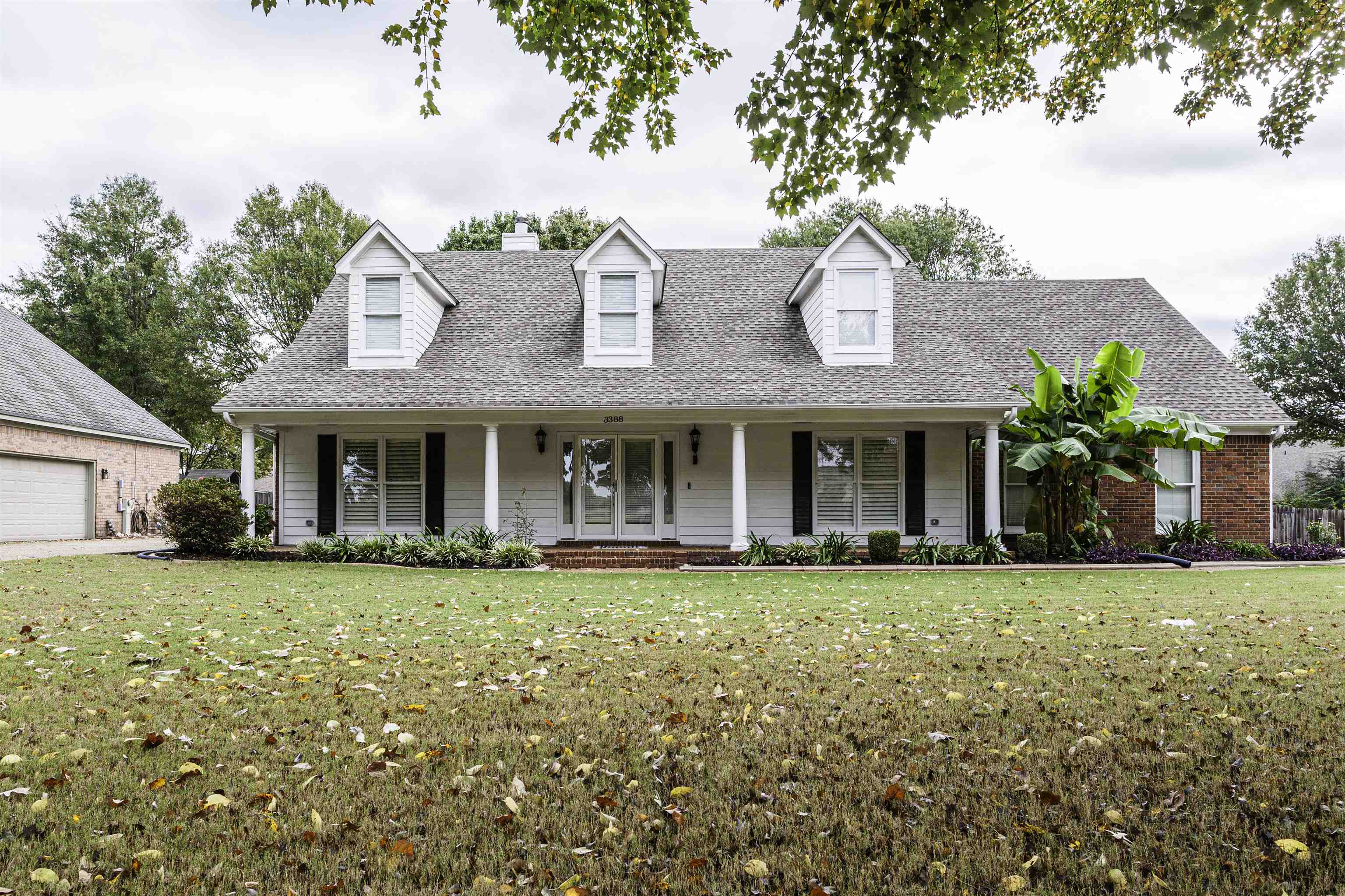 a front view of a building with a garden