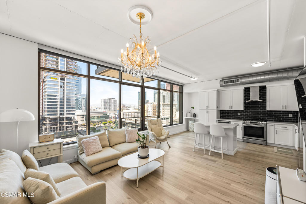 a living room with furniture and a chandelier