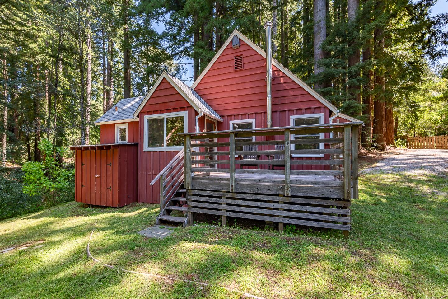 a view of a house with a yard and wooden fence