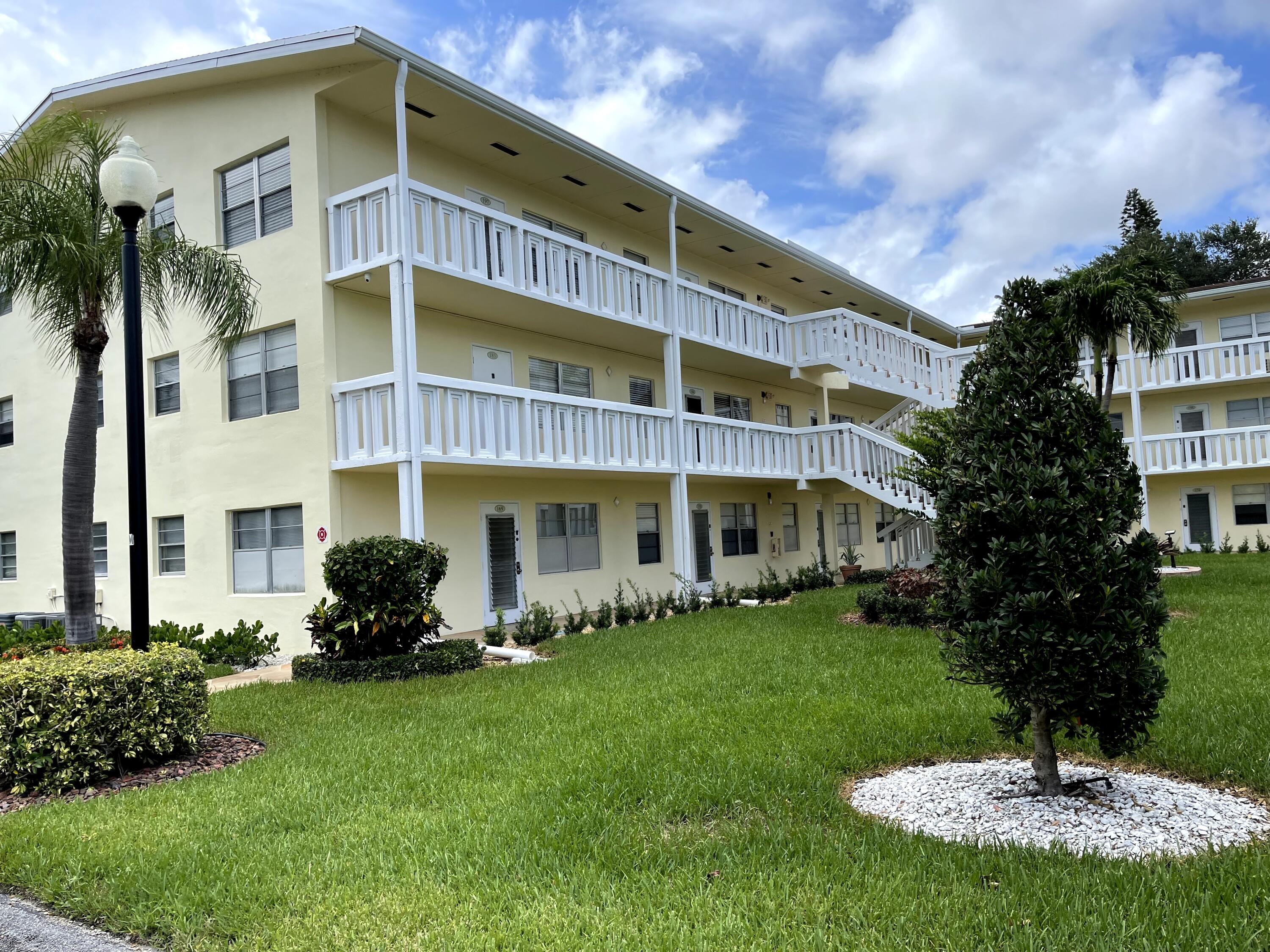 a front view of a building with garden