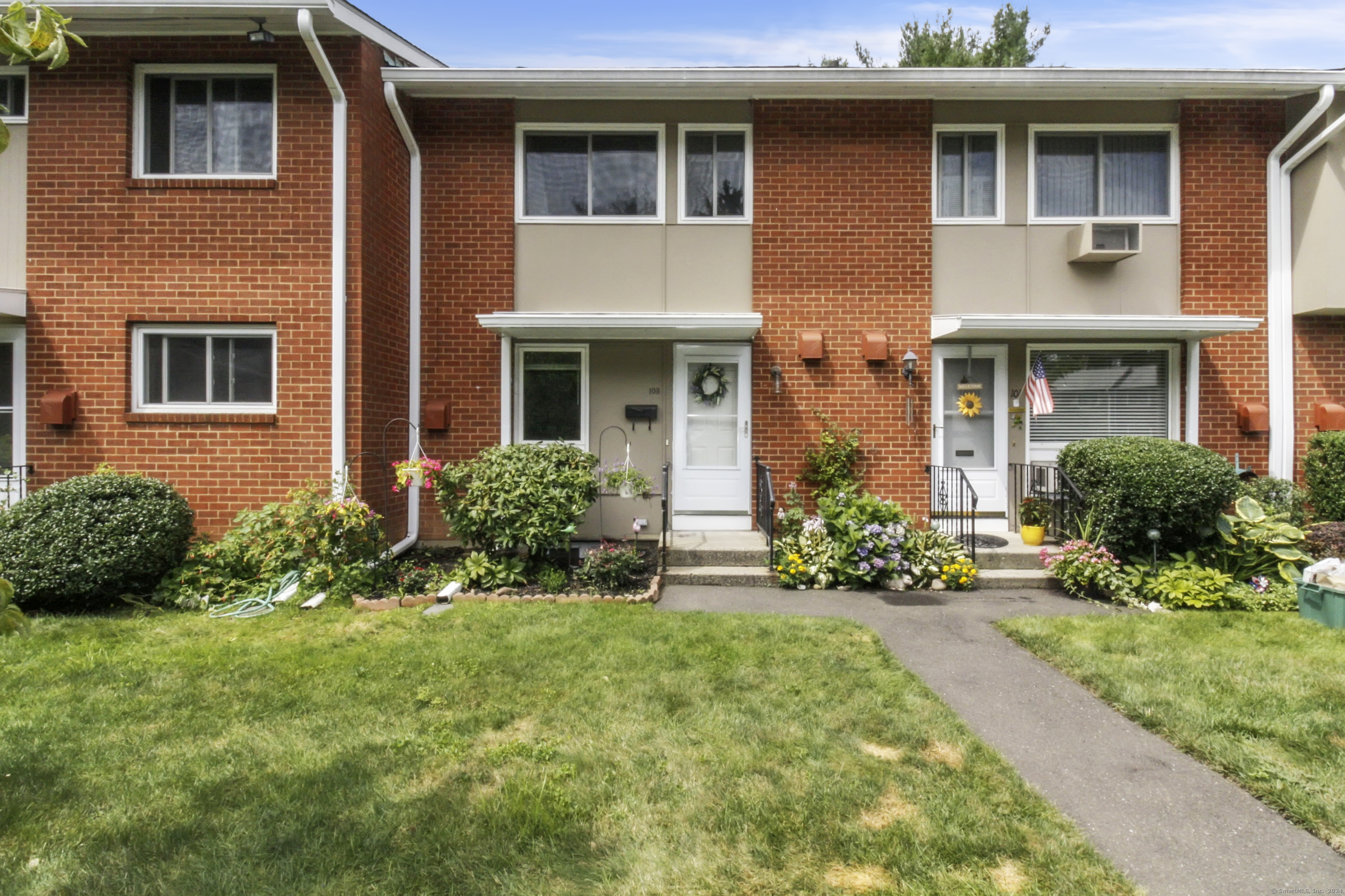 a front view of a house with yard and green space