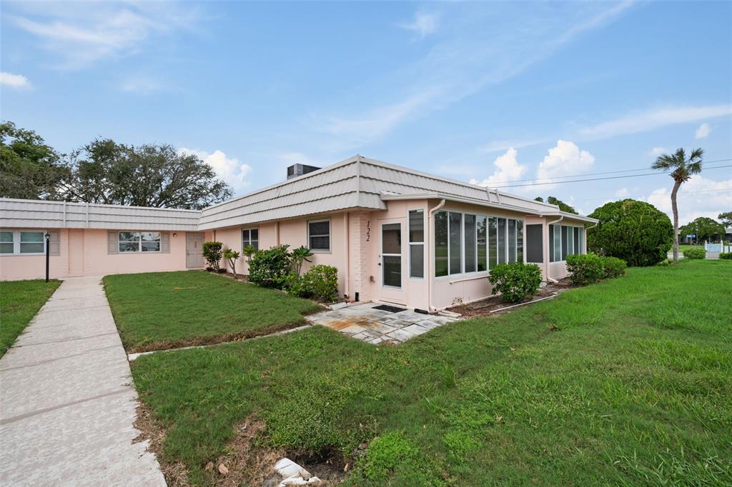 a front view of a house with a yard and porch