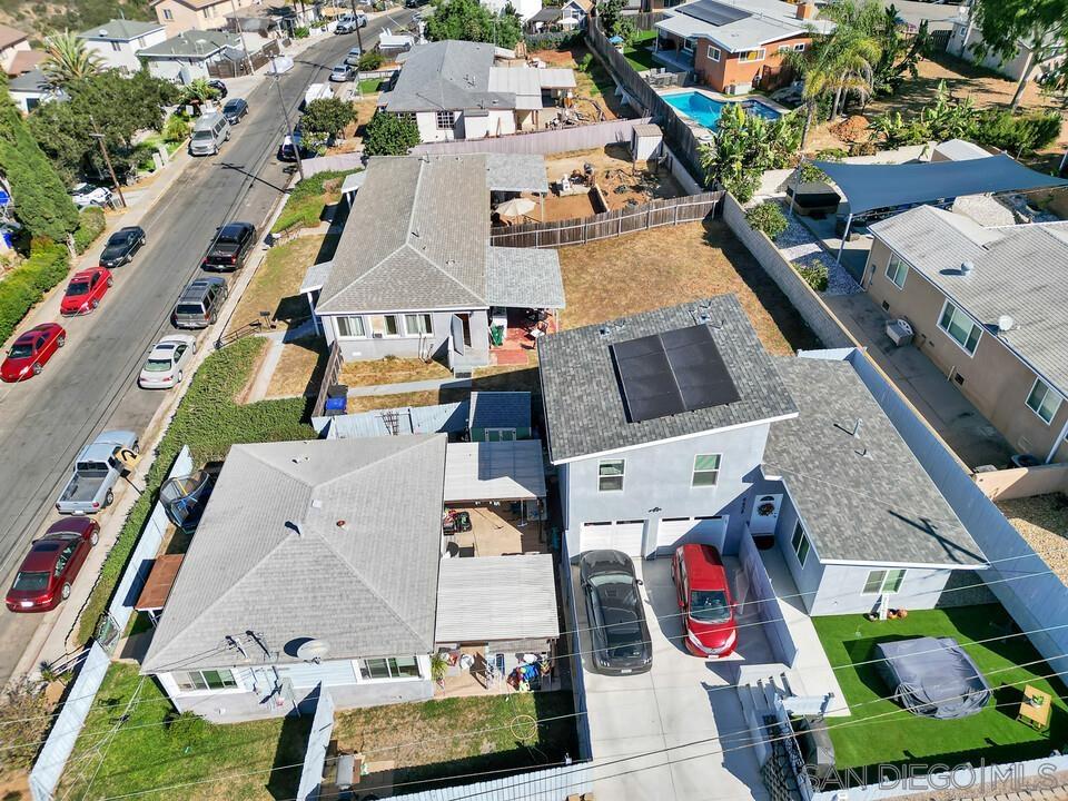 an aerial view of residential houses with outdoor space