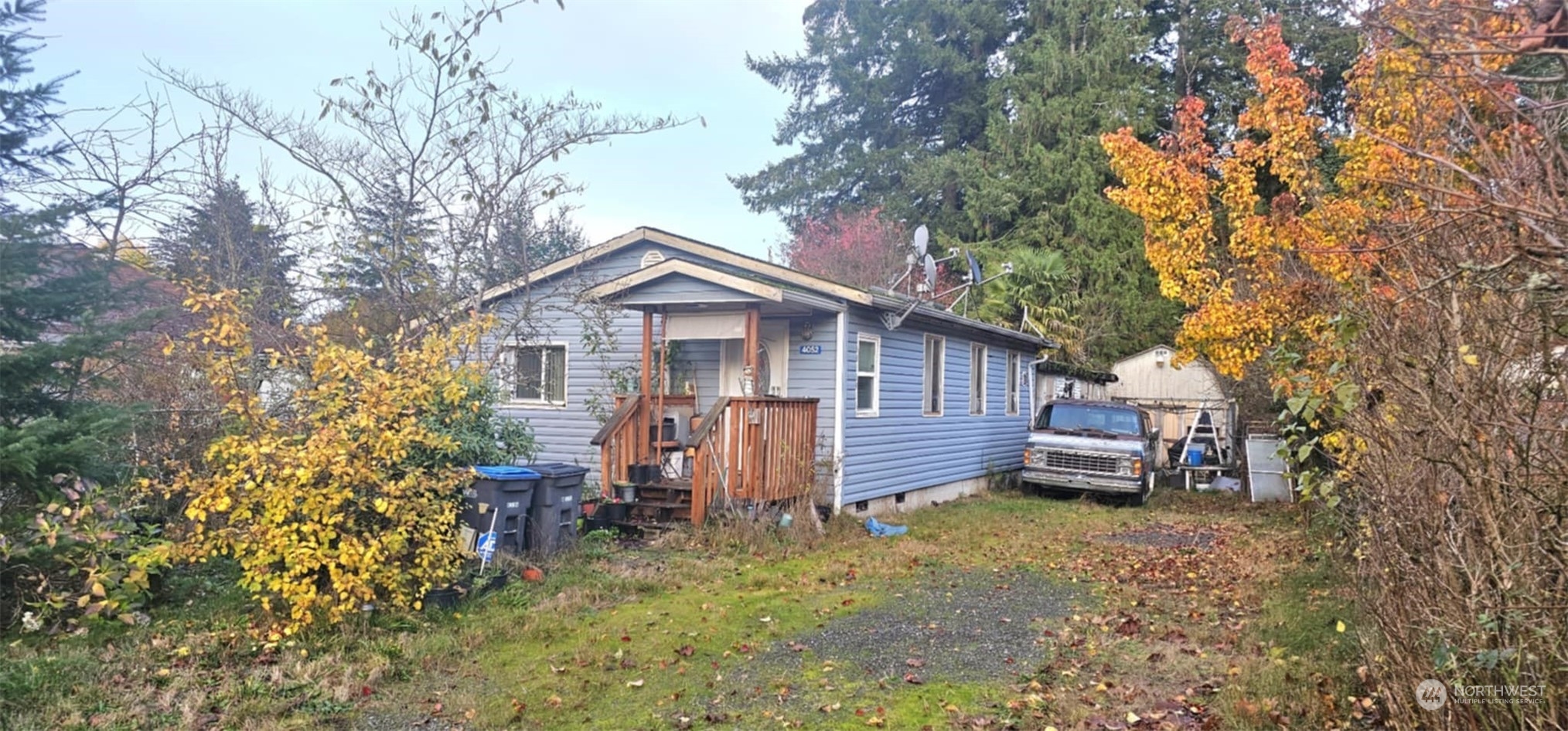 a view of a house with a yard and sitting area