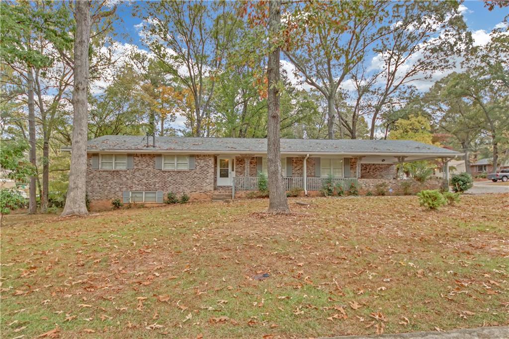 front view of a house with a large trees