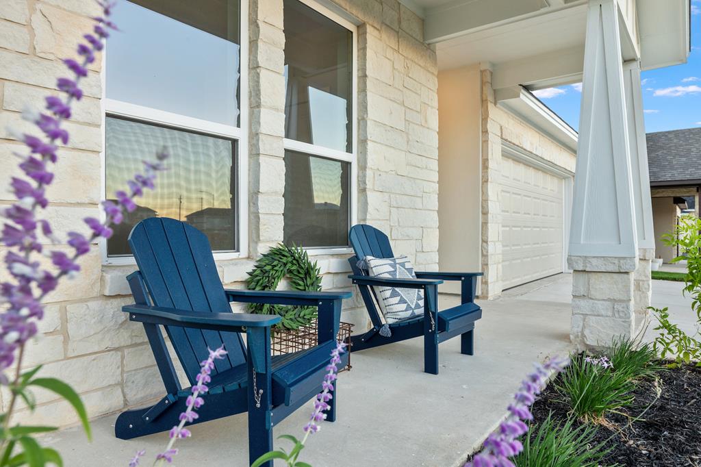 a view of balcony with chairs and table