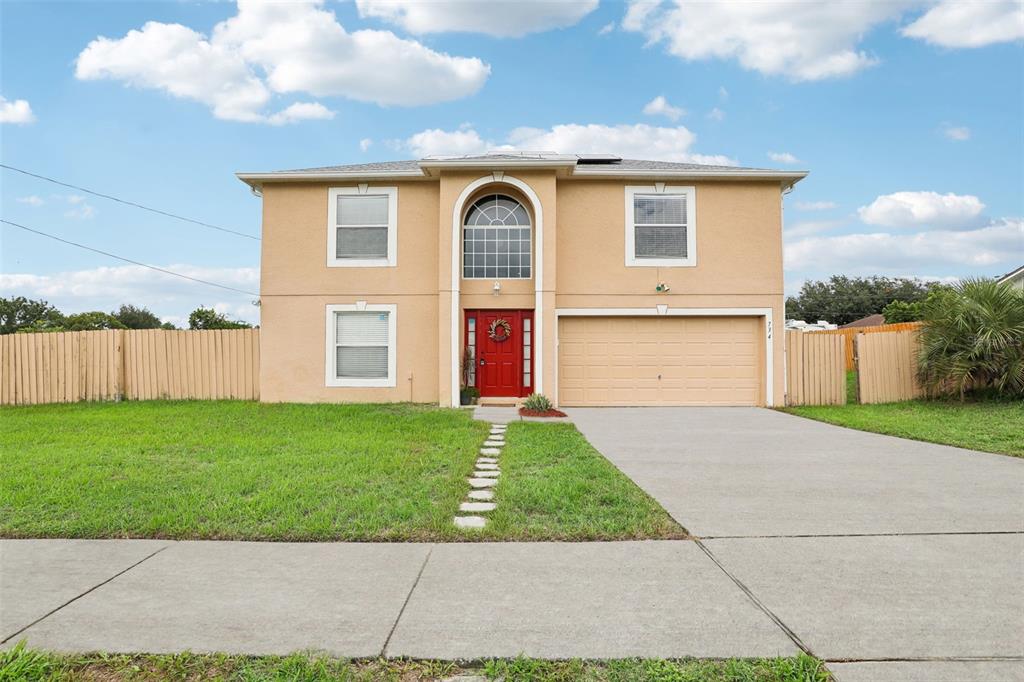 a front view of a house with a yard and garage