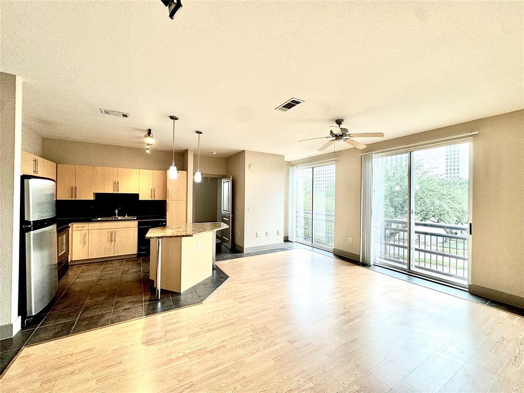 a view of kitchen with furniture and a refrigerator