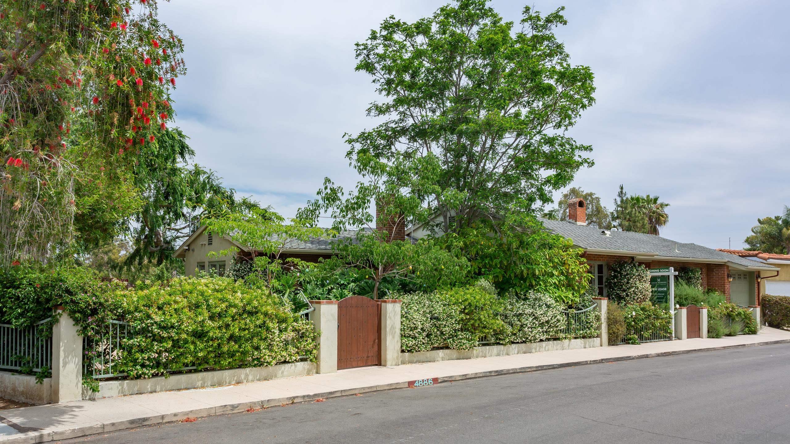 front view of a house with a tree