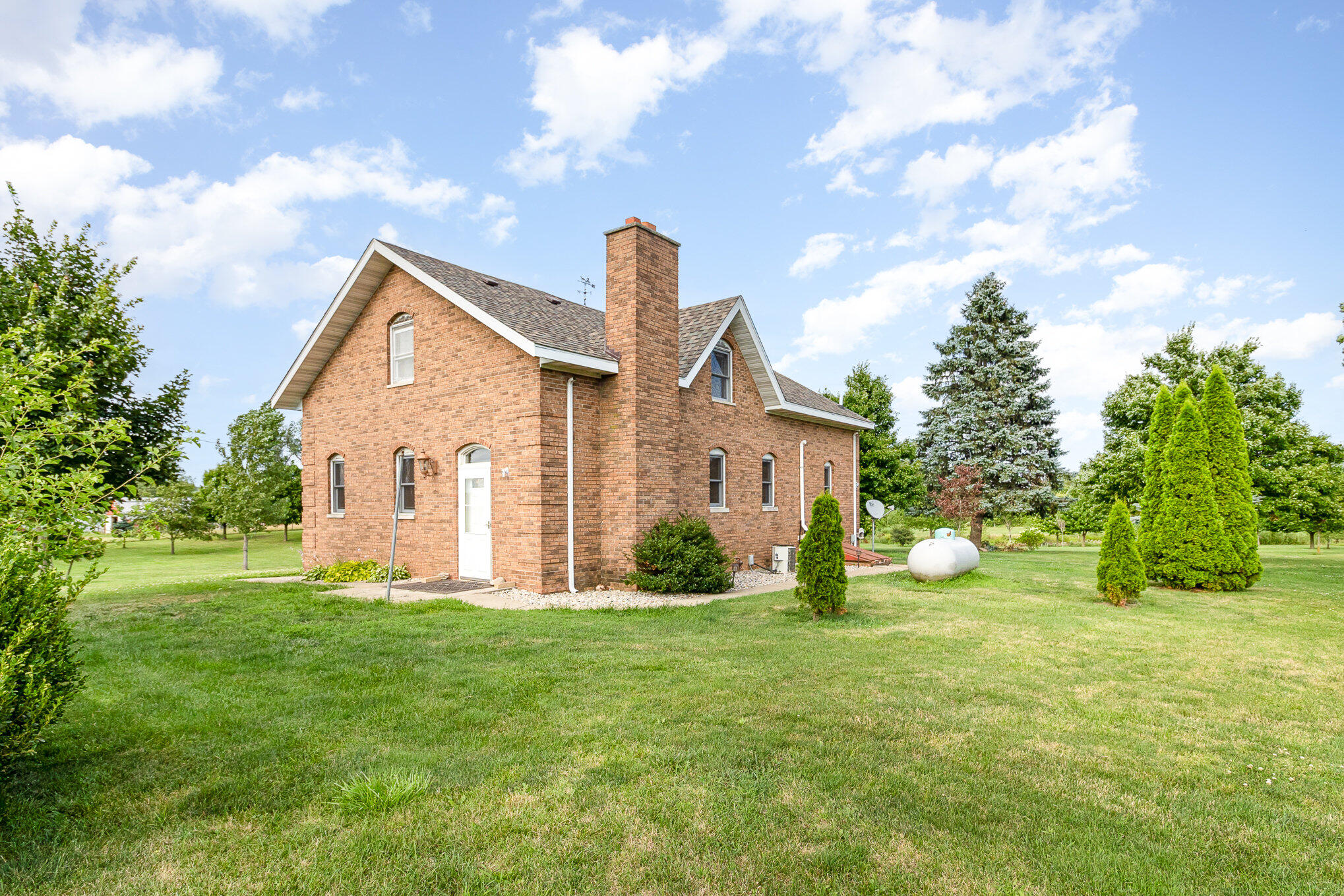 a view of a house with yard and a garden