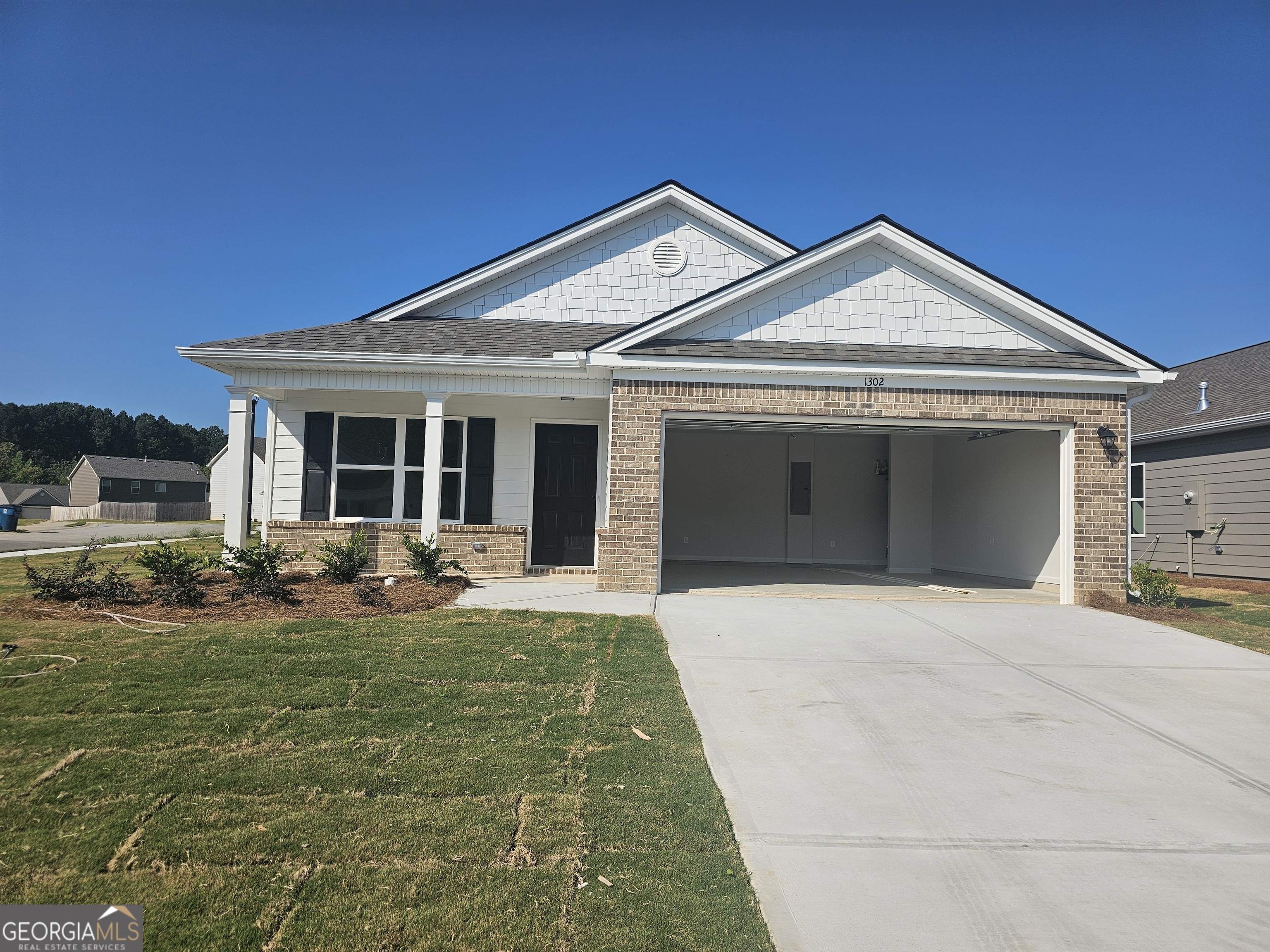 a front view of a house with yard and green space