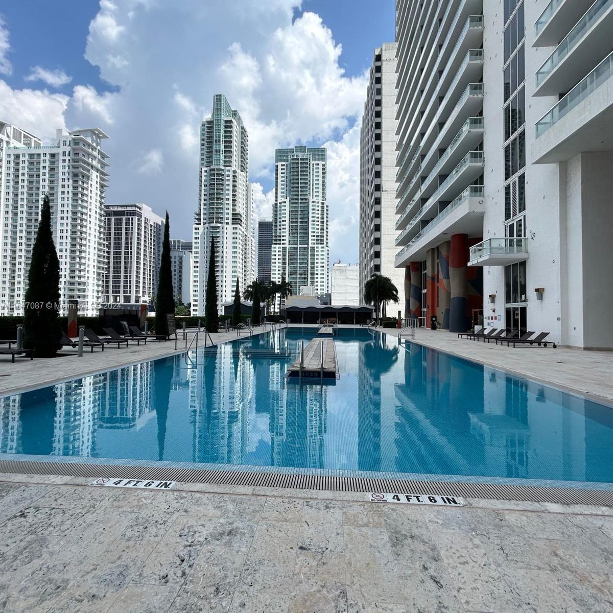 a swimming pool with outdoor seating and yard