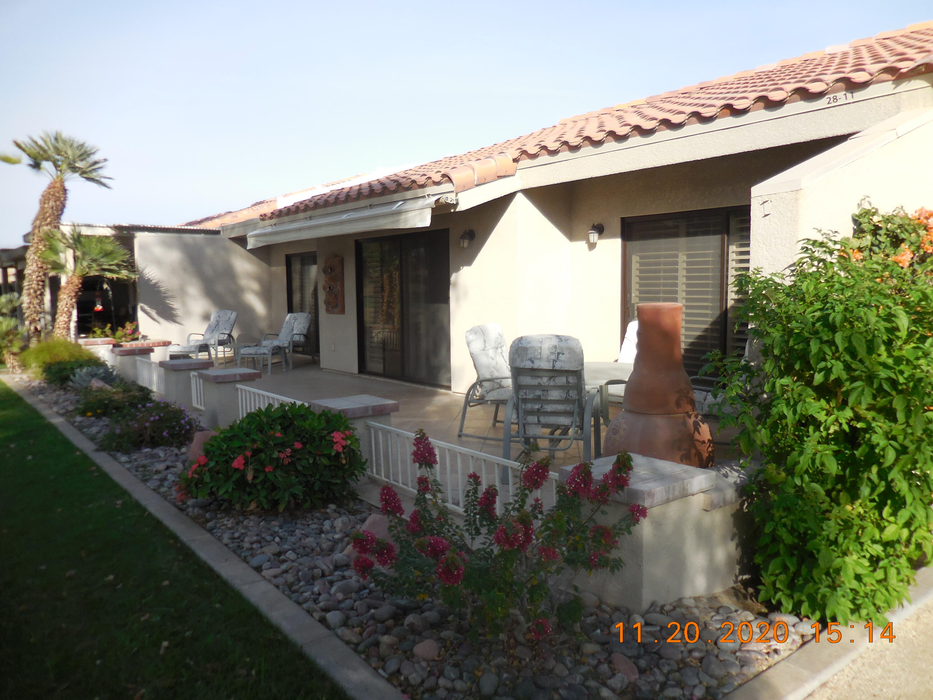 a view of a house with fountain in front of it