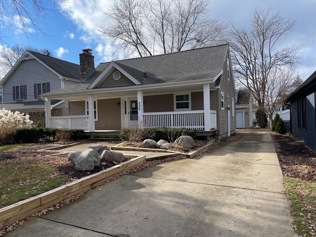 a view of house with yard outdoor seating area