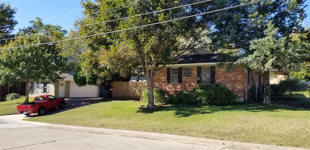 a view of a house with a patio and a yard