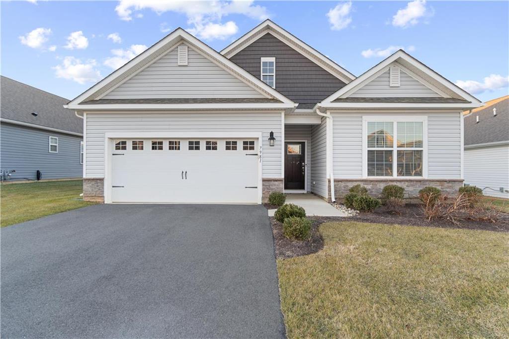 a view of a house with a yard and garage