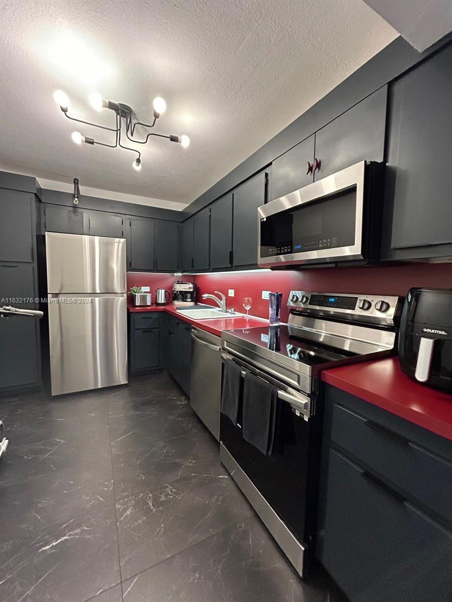 a kitchen with a stove and a refrigerator