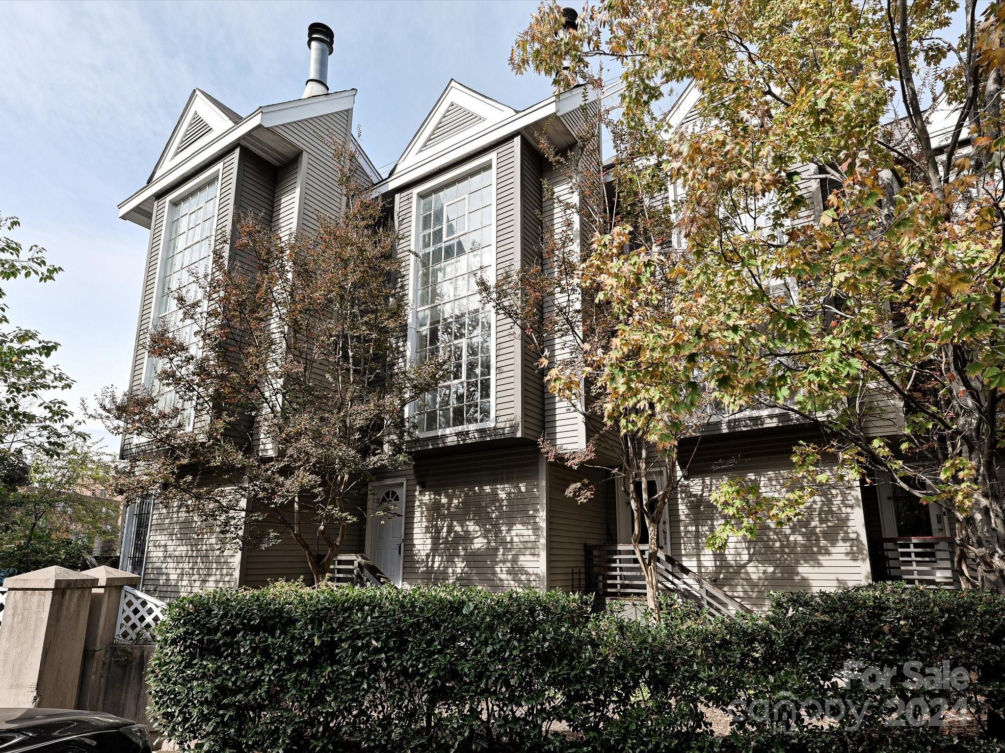 a front view of a house with plants