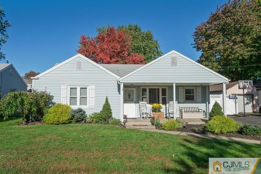 a front view of a house with a yard and porch