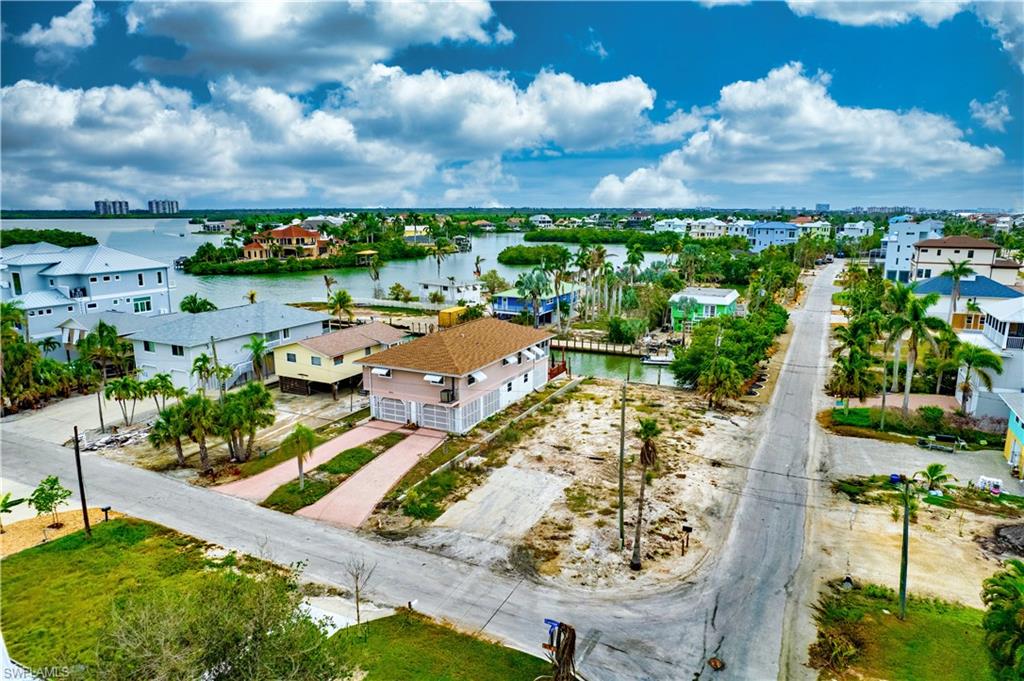 Birds eye view of property with a water view