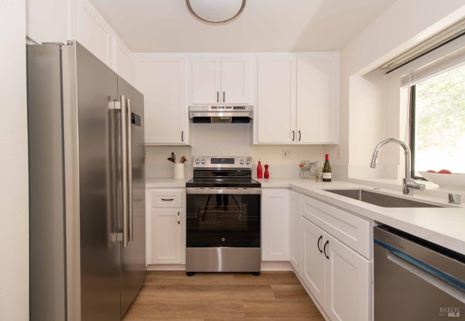 a kitchen with a sink and stainless steel appliances