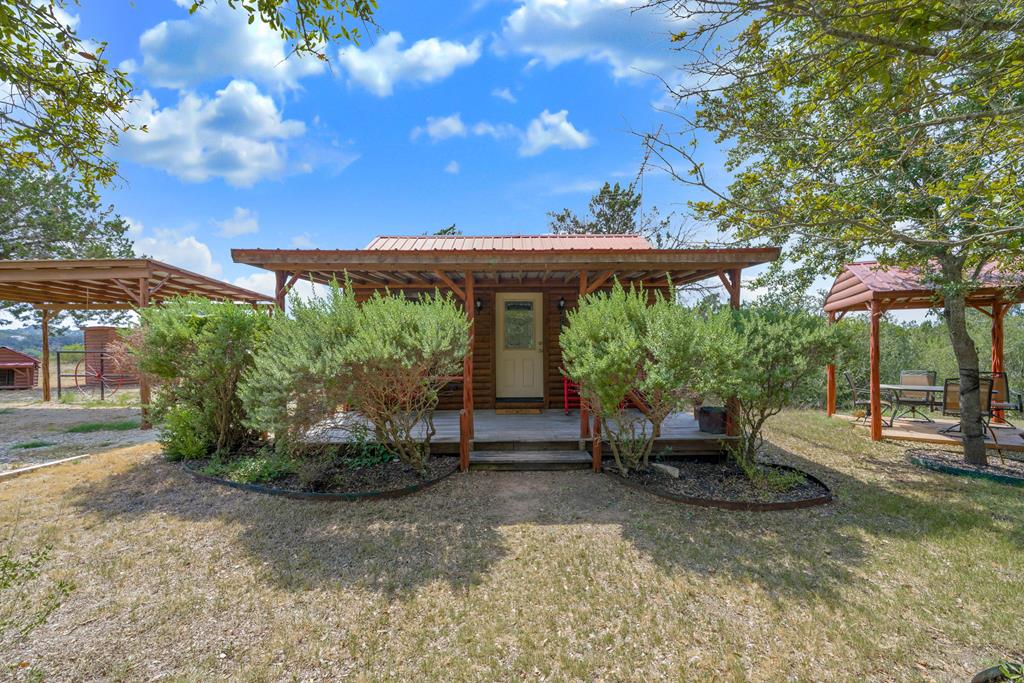 a view of house with backyard outdoor seating and green space