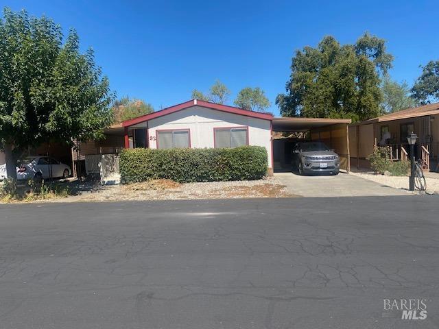 a view of house with yard and street view