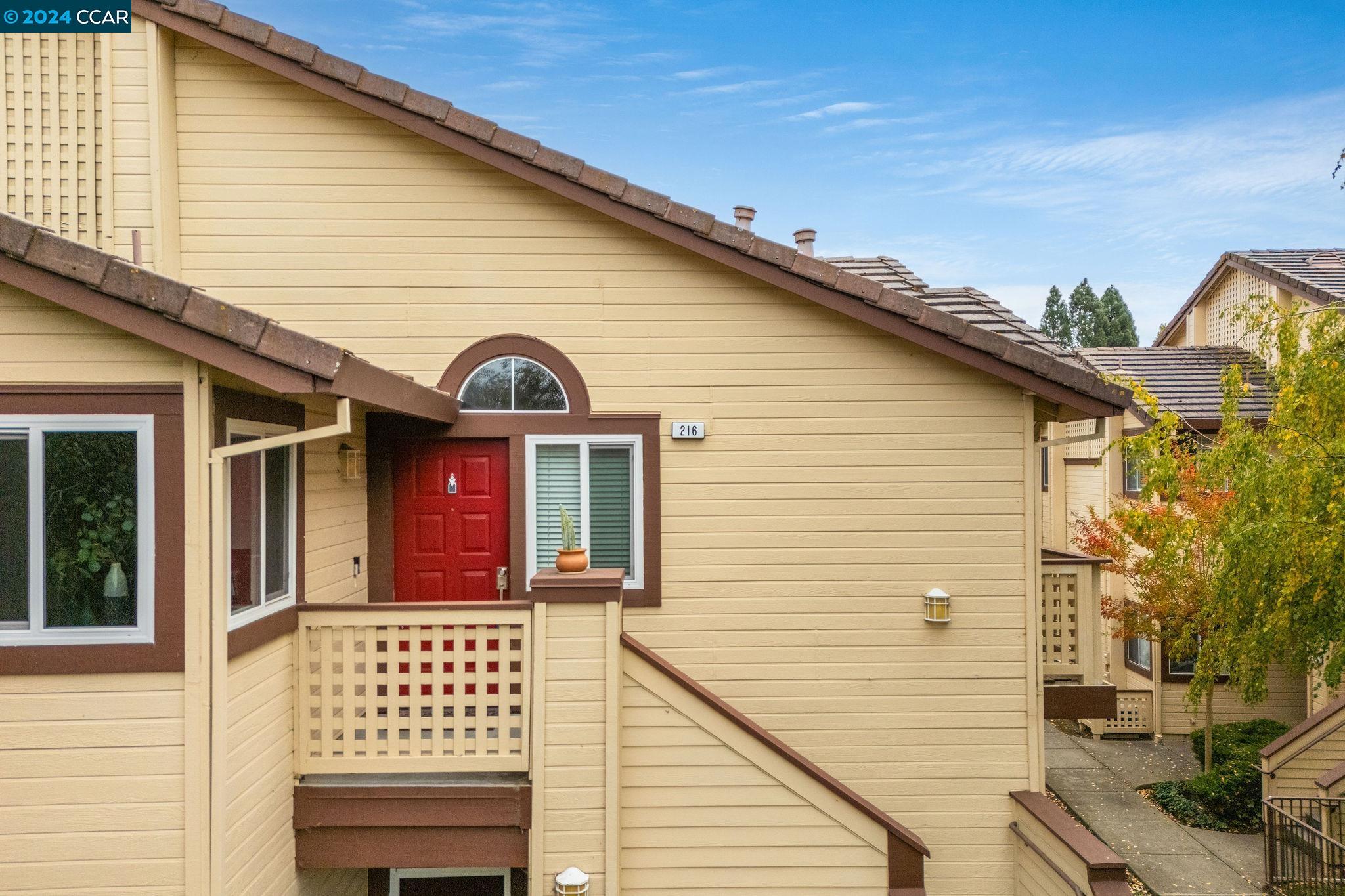 a view of front of a house with a balcony