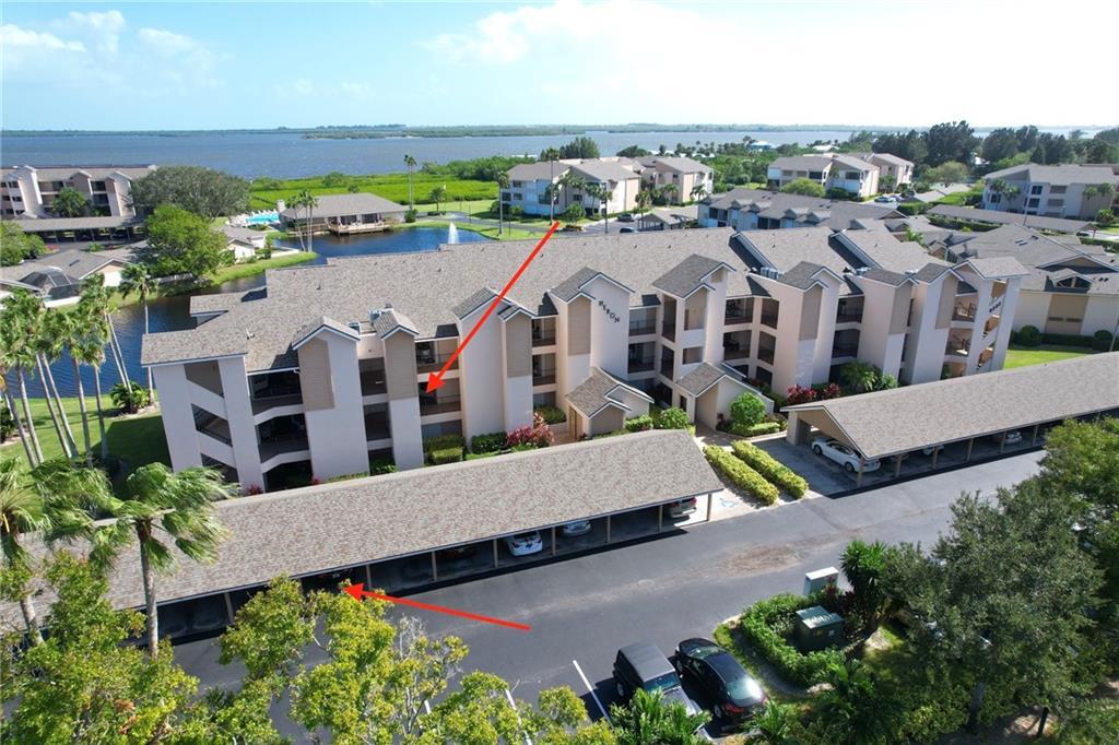 an aerial view of multiple houses with a yard