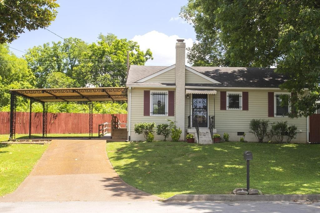 a front view of house with yard and green space