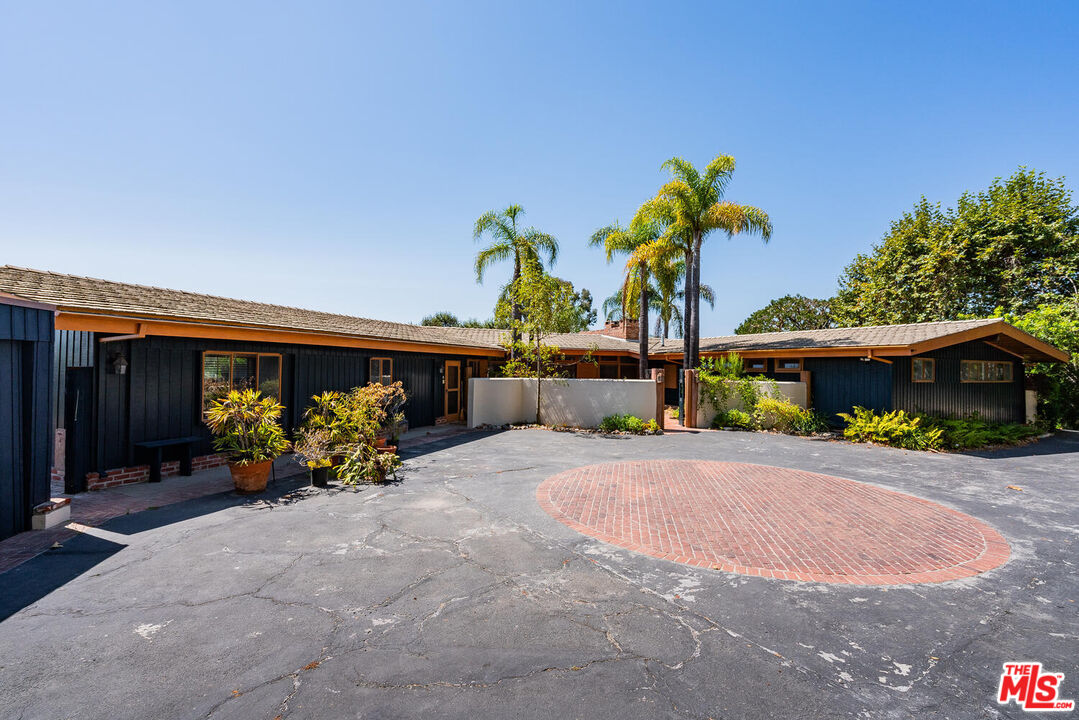 a front view of a house with a yard and seating space