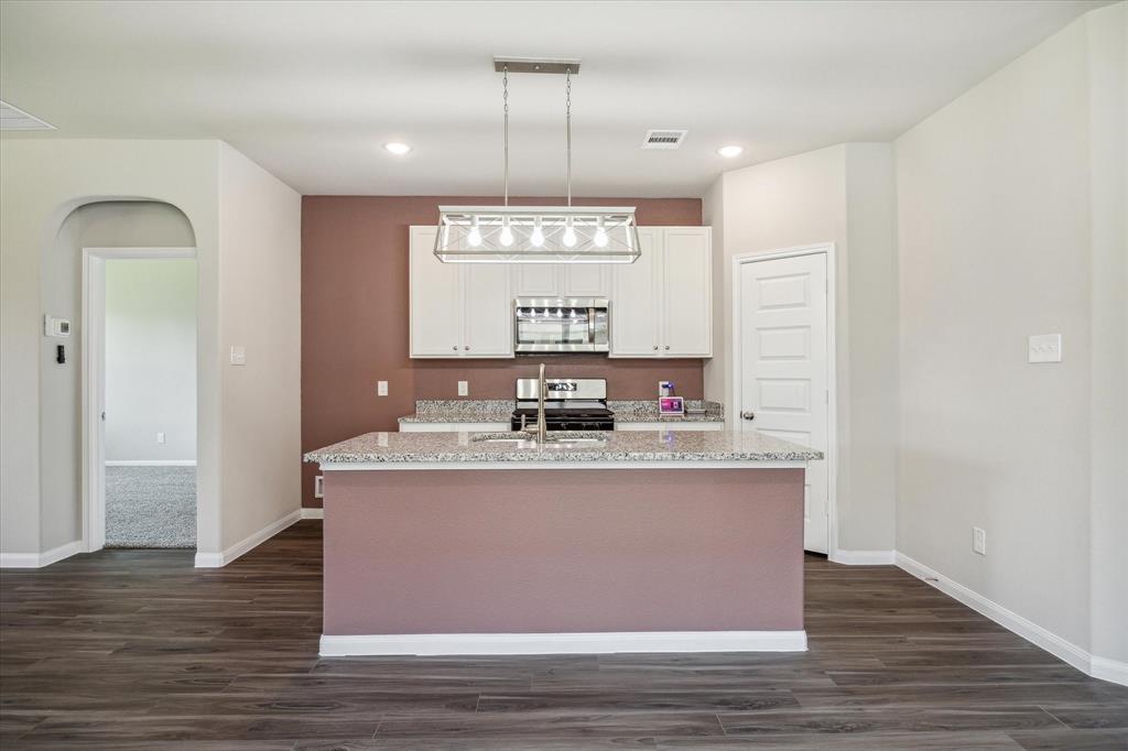 a view with counter top space sink and window