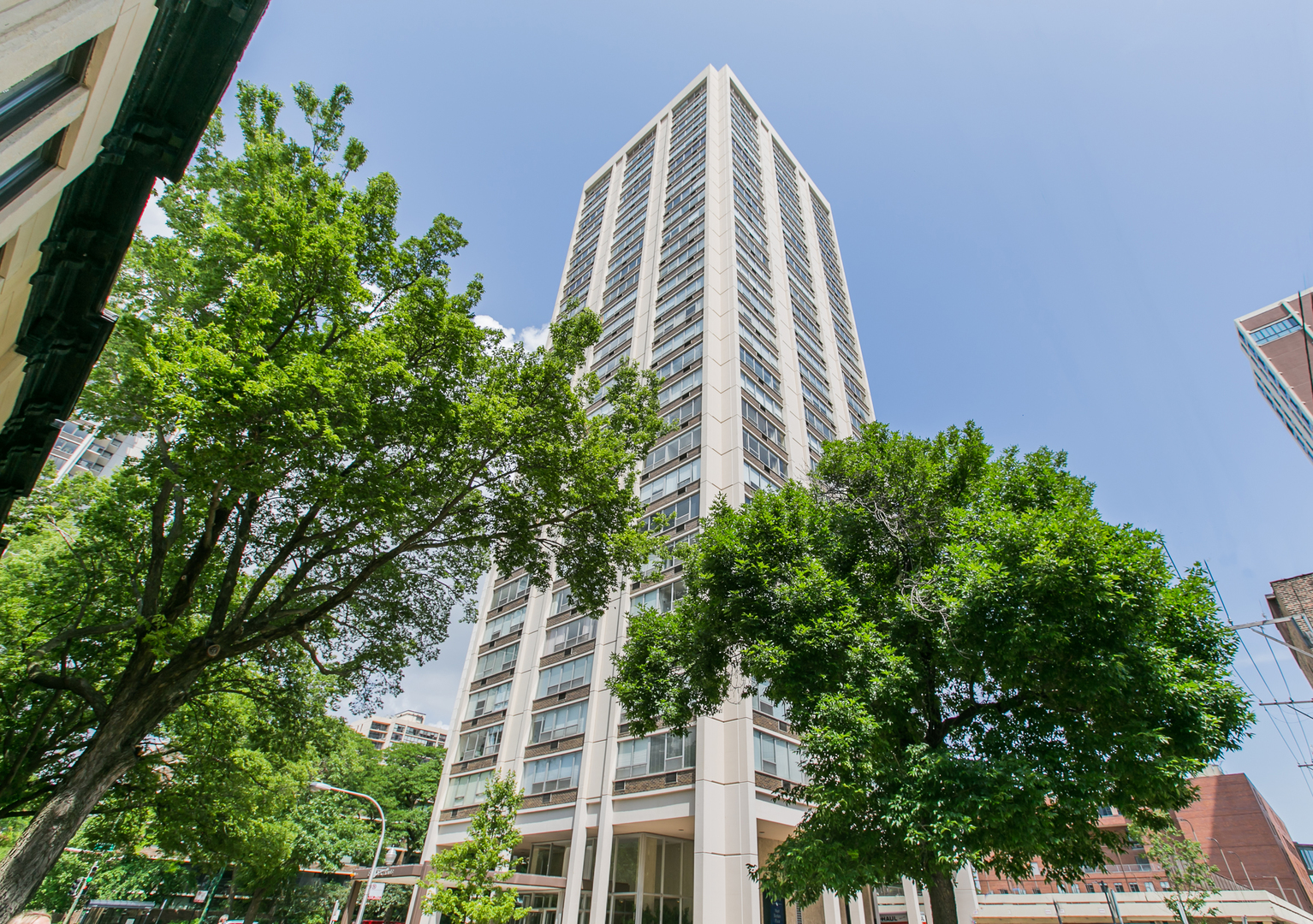 an aerial view of a multi story building and trees